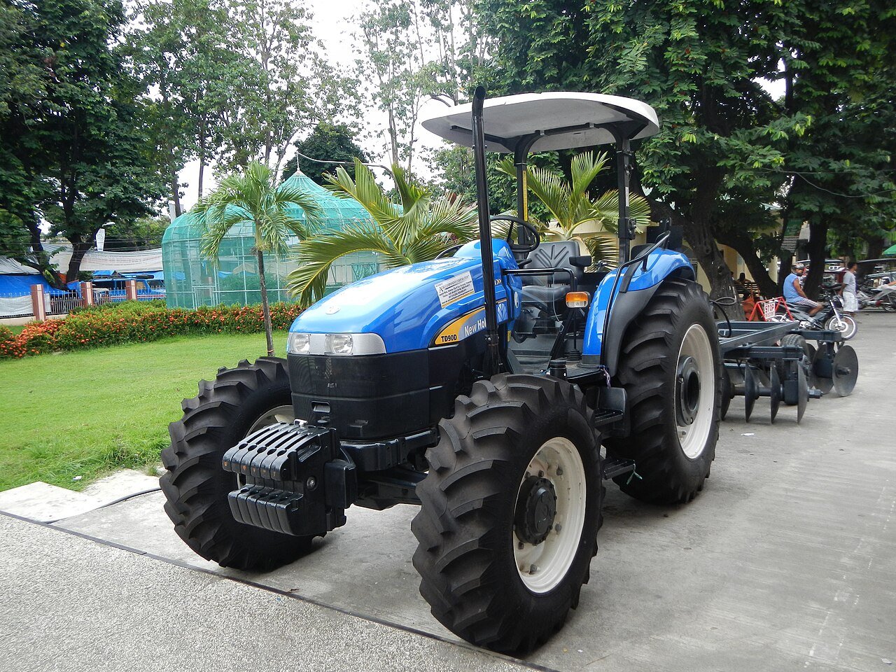 A blue farm tractor with a tillage attachment in Camiling, Tarlac